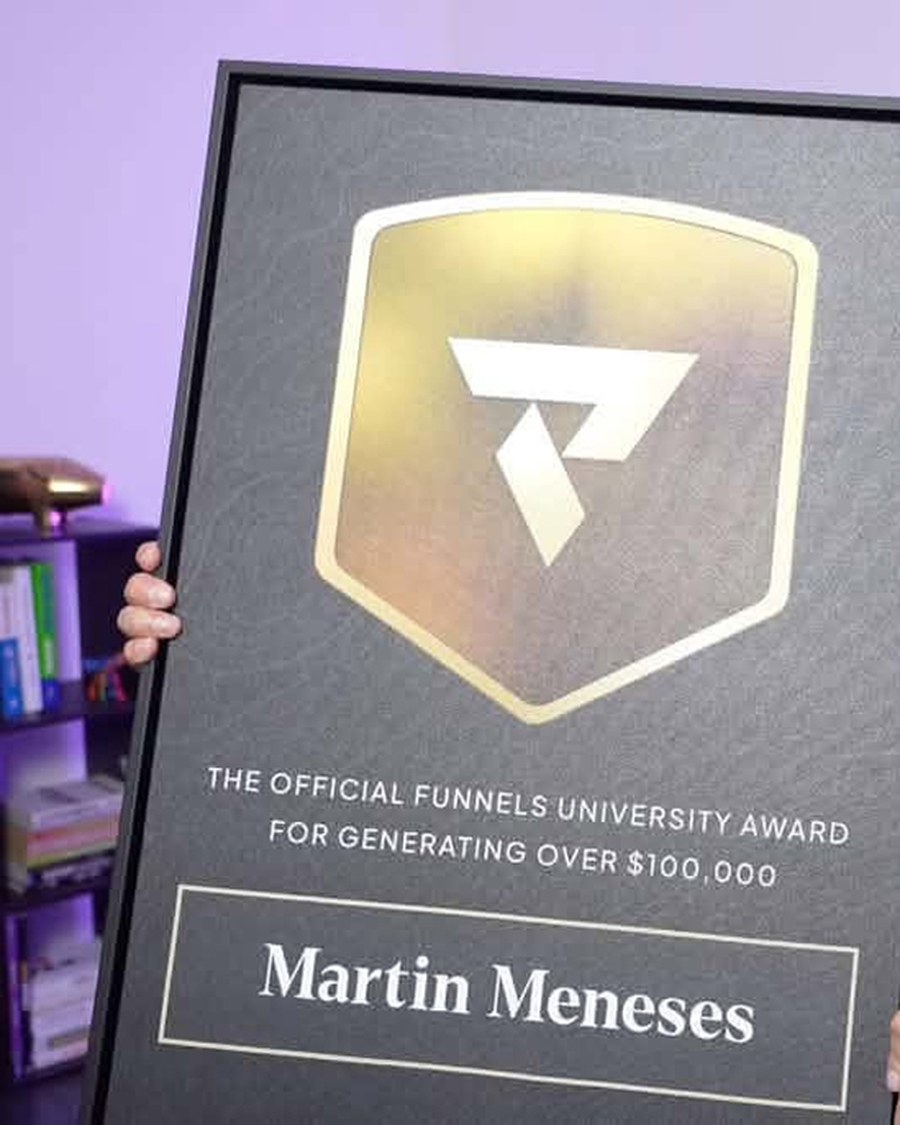 Martin Meneses holding the Funnels University $100K Award
