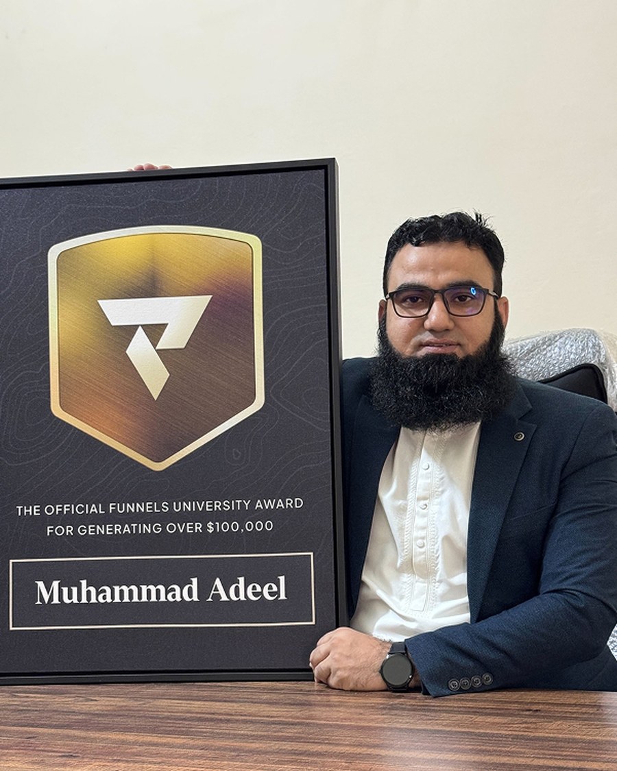 Muhammad Adeel holding the Funnels University $100K Award