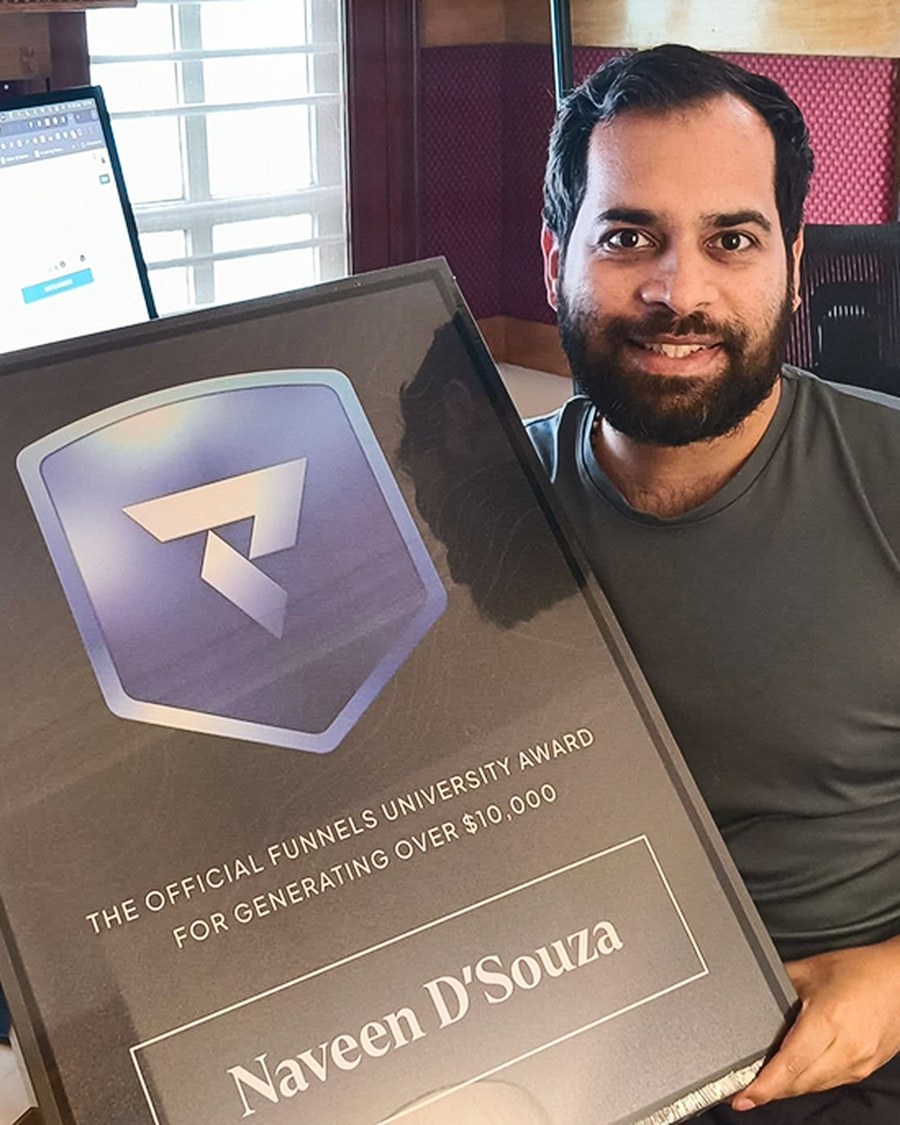 Naveen D'Souza holding the Funnels University $10K Award